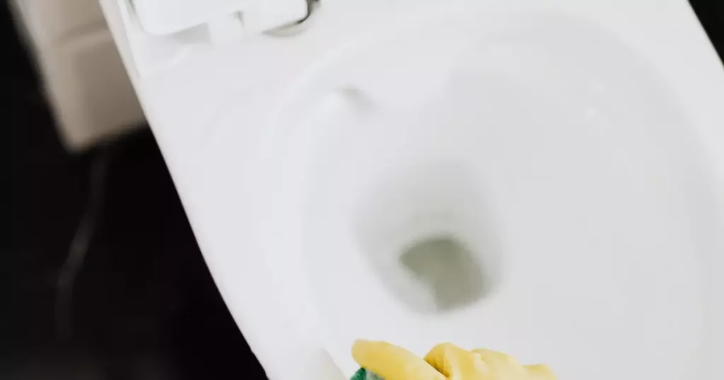 best way to clean behind toilet